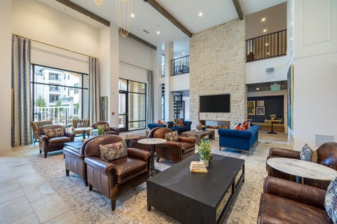 a living room with couches and chairs and a fireplace